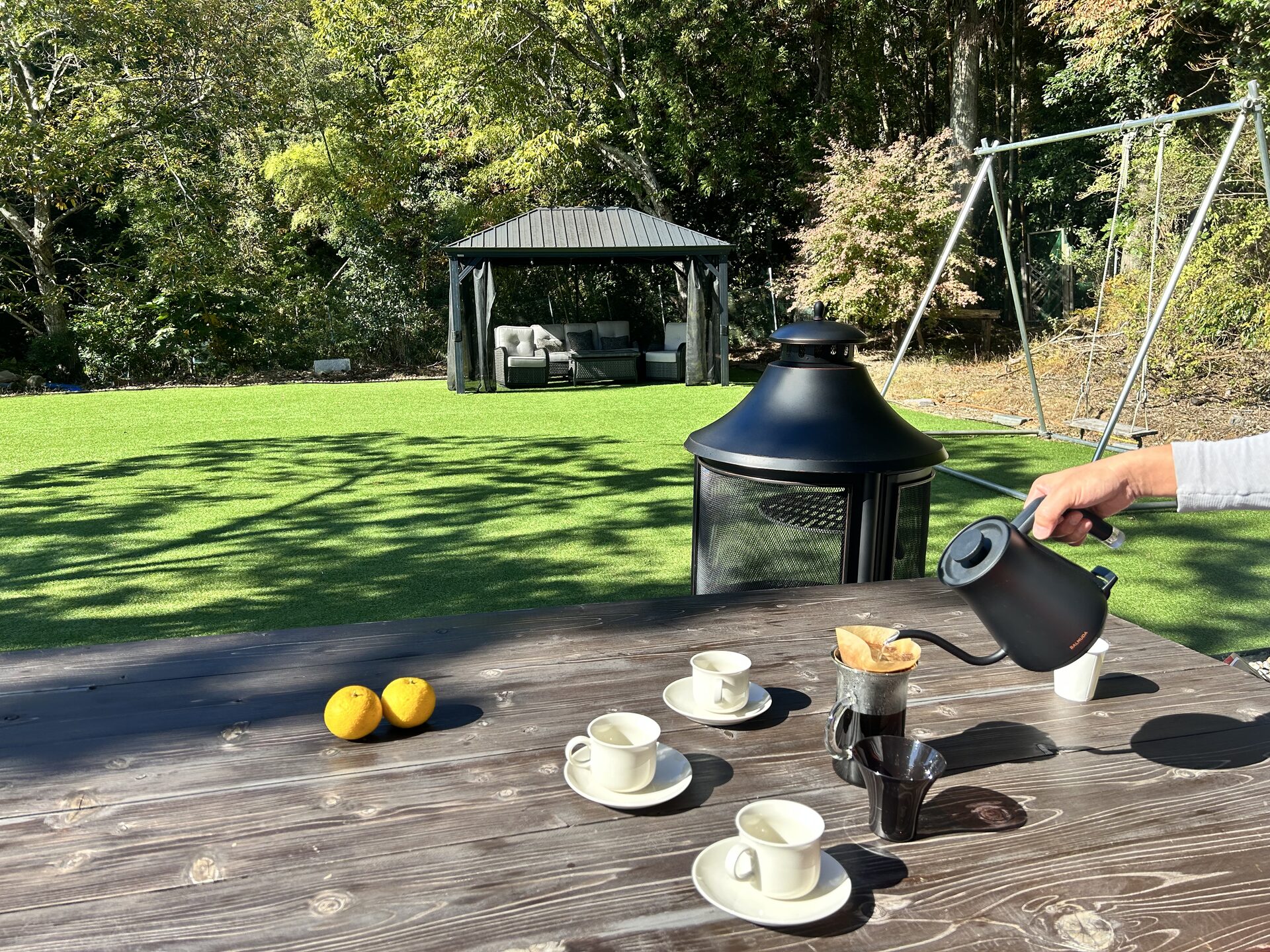 Brewing coffee in BlueFlow KATSUURA's garden, with a gazebo and swing on the lawn